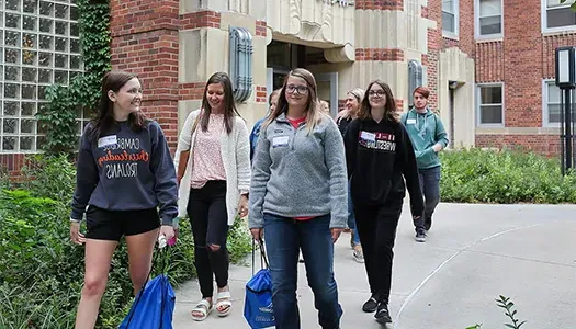 students walk outside during a campus tour